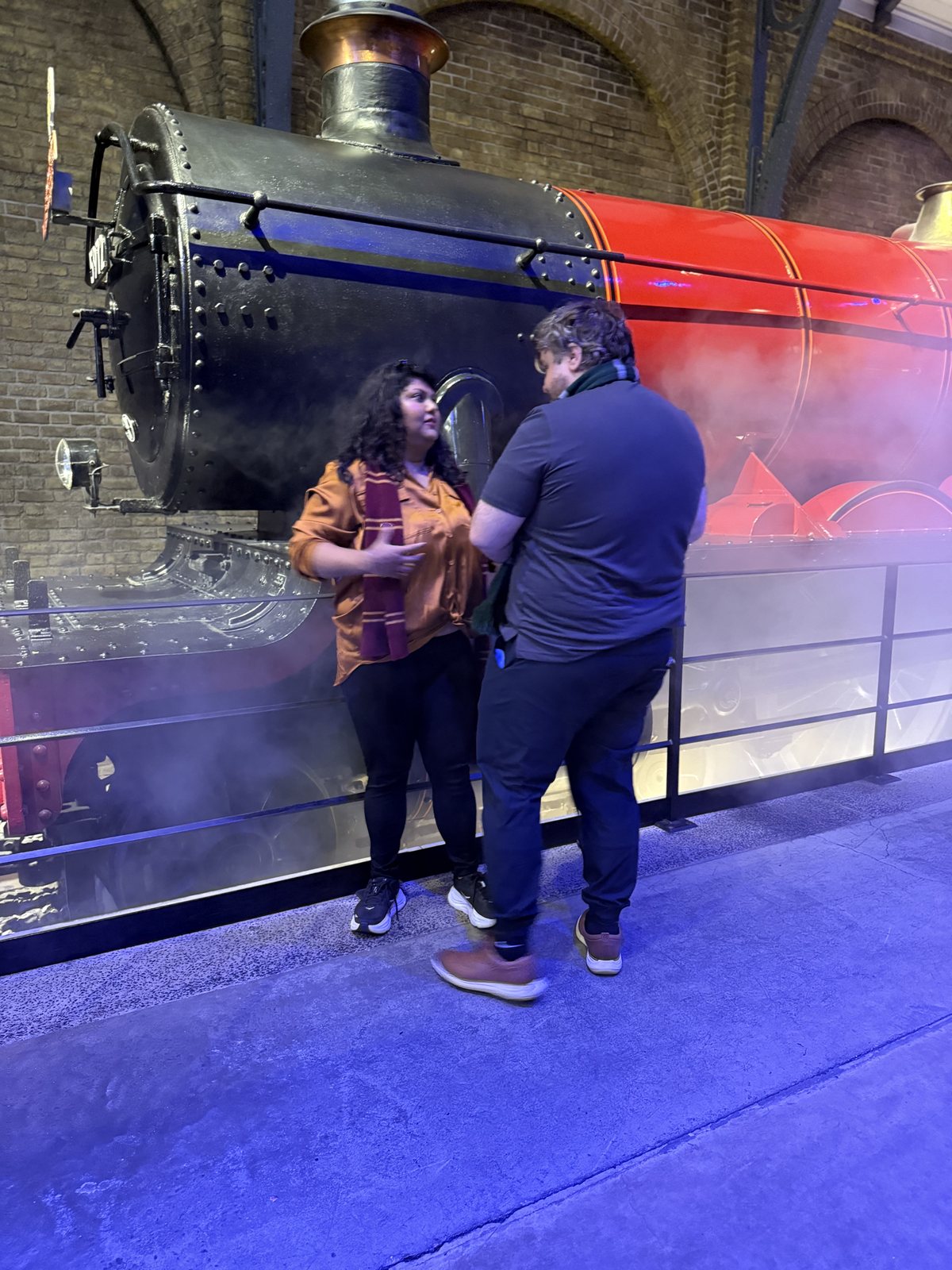 Monica and Austin beside the Hogwarts Express, moments before the proposal